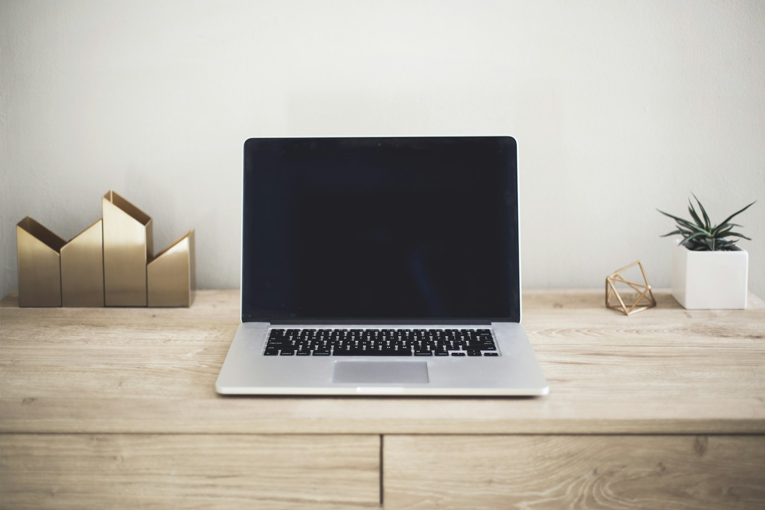 A laptop in a clean, light-filled workspace